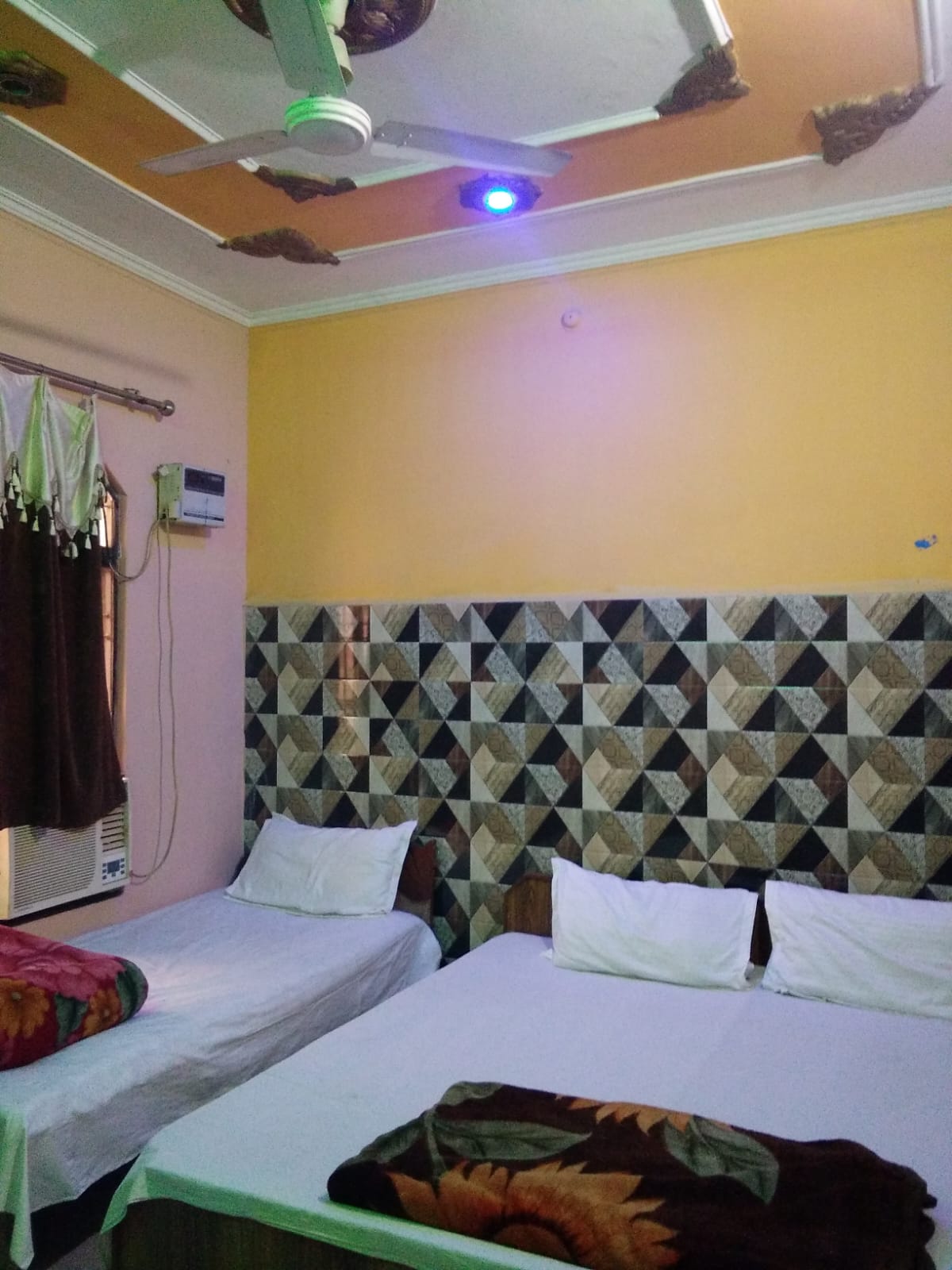 Guest room at Shiv Dham Home Stay with beds and patterned wall
